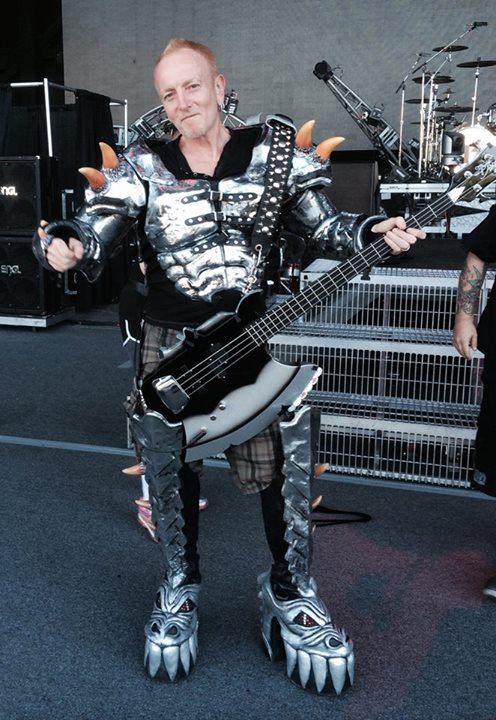 Def Leppard's Phil Collen sporting Gene Simmons costume and bass
