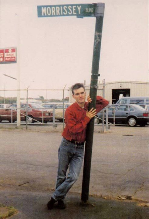 Morrissey standing under the street sign for Morrissey Blvd