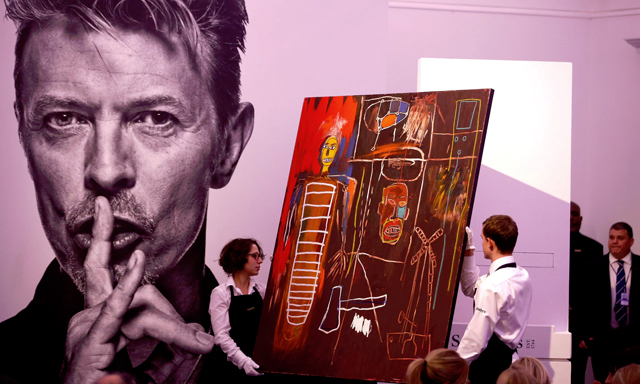 Jean-Michel Basquiat’s Air Power is removed from a plinth by Sotheby’s staff after its sale. Photograph: Peter Nicholls/Reuters