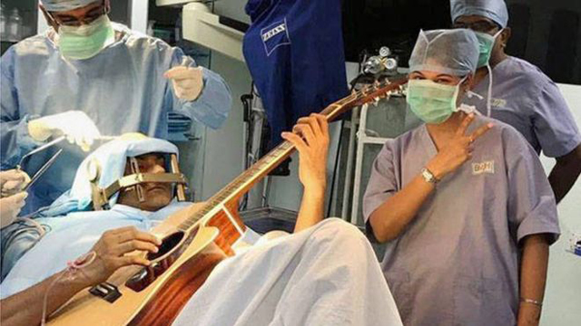 India musician plays guitar during brain surgery