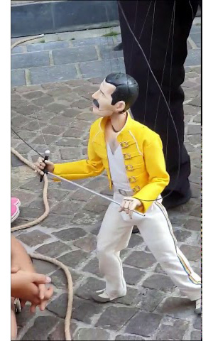 Freddie Mercury dances as a puppet street performance