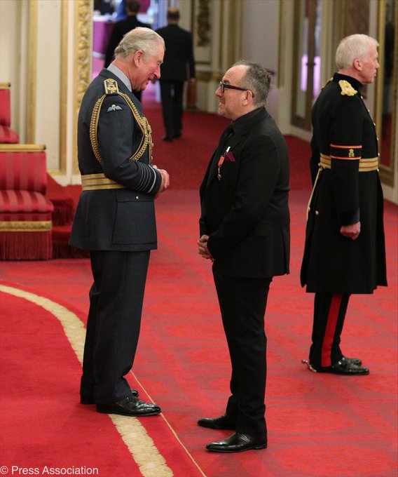 Elvis Costello gets OBE at Buckingham Palace