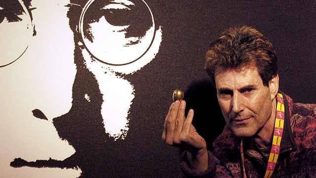 Uri Geller with an egg-shaped object in front of picture of John Lennon (2005)IMAGE SOURCE,GETTY IMAGES