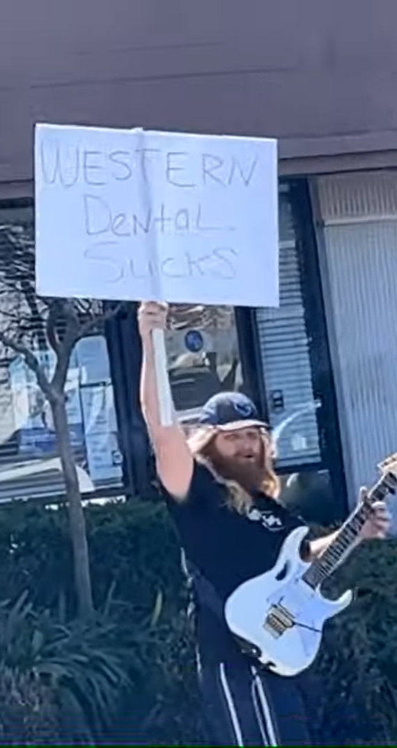 Guy plays guitar outside of dental office