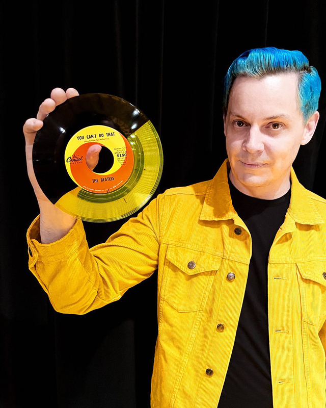 Jack White with yellow-and-black split color version of the Beatles' 1964 single 