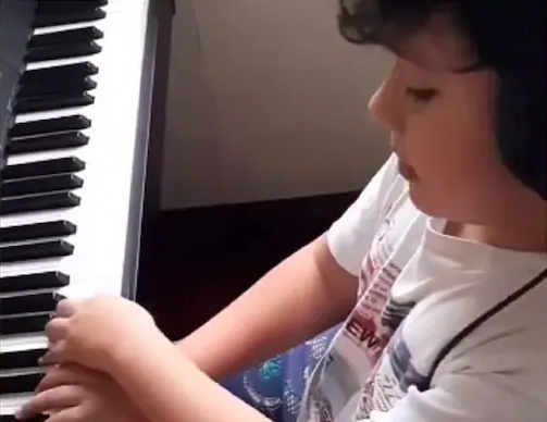 Young boy performs cover of 'Bohemian Rhapsody' on the piano
