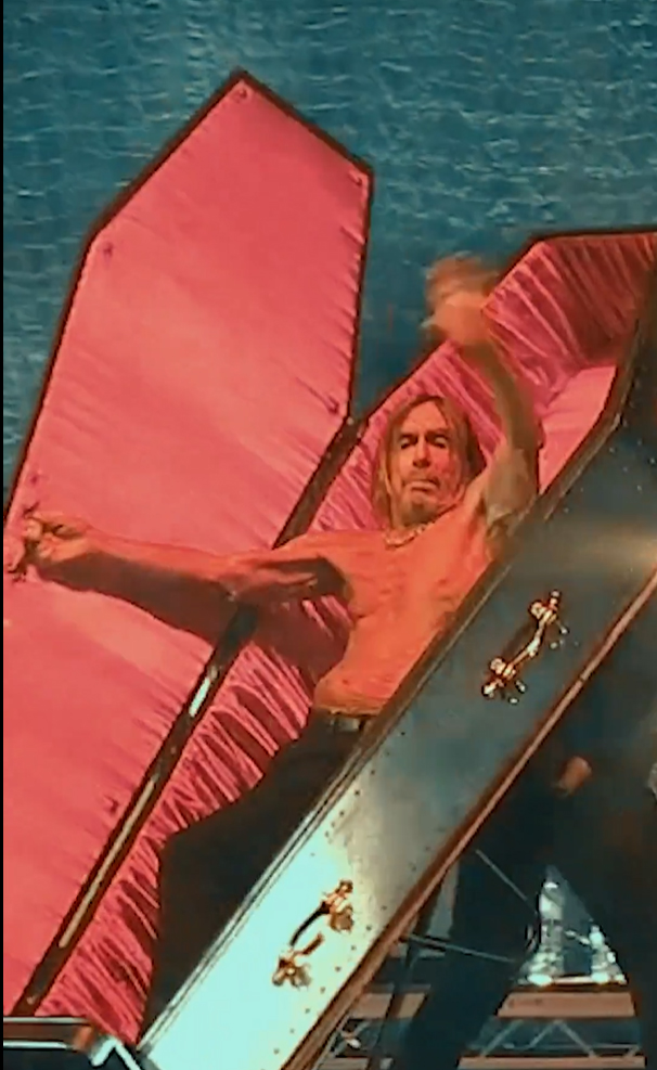 Iggy Pop Exiting the Stage In a Coffin During Concert