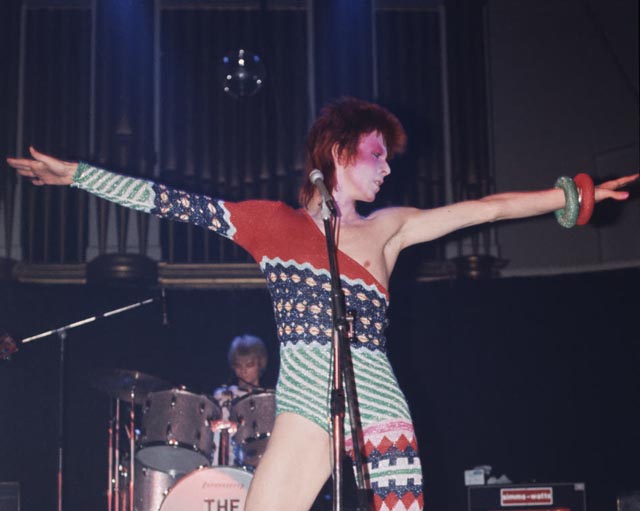 David Bowie performing as Ziggy Stardust wearing a catsuit designed by Kansai Yamamoto, 1973, photographed by Mick Rock. Photograph: Mick Rock/Victoria and Albert Museum, London